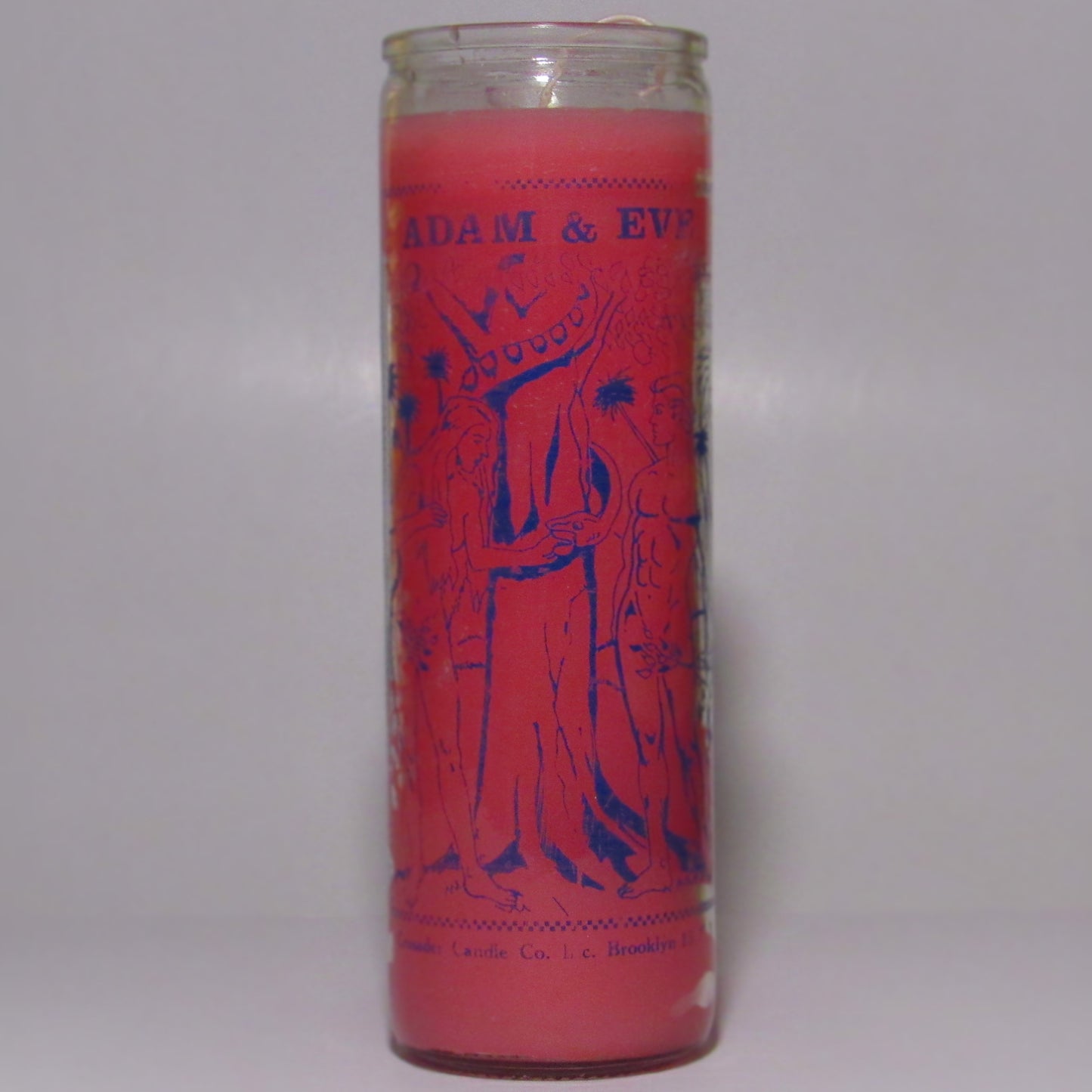 Pink candle with 'Adam & Eve' illustration