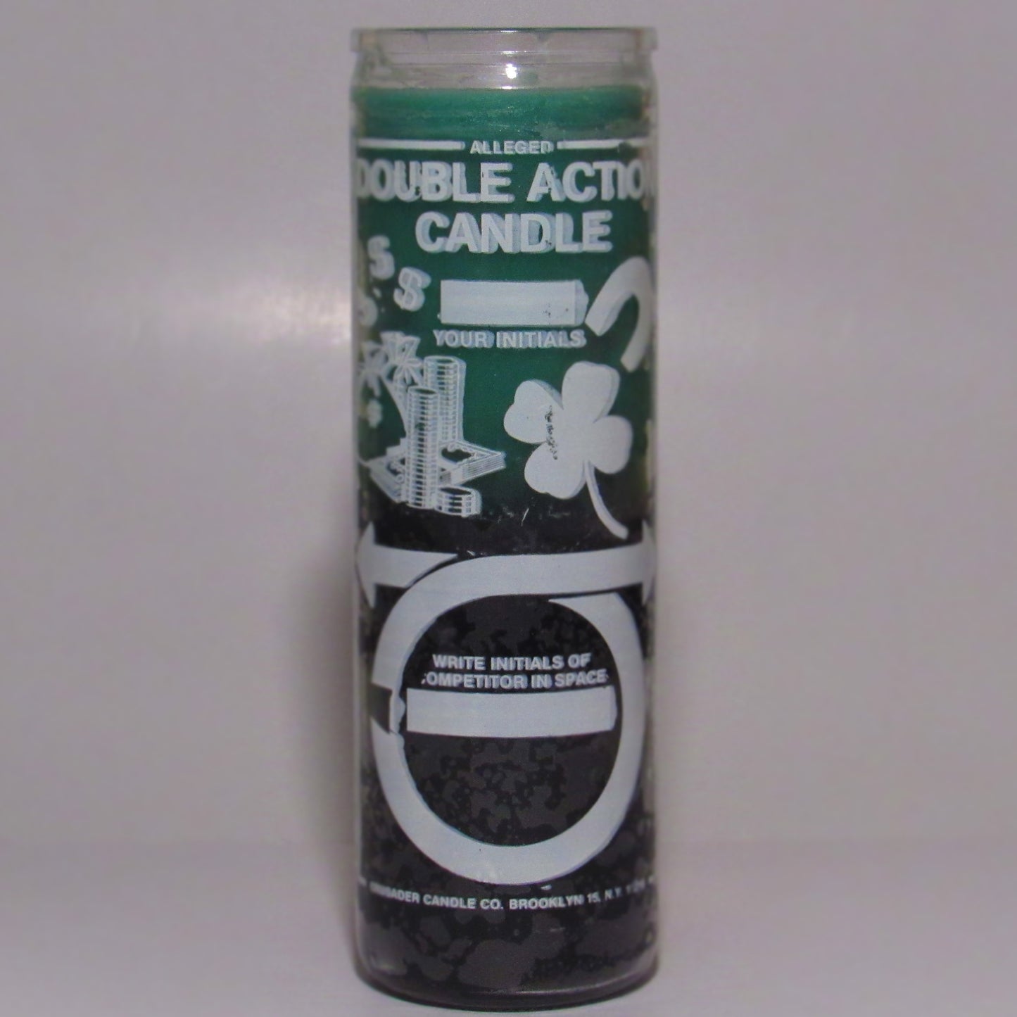 Green and white candle with text and graphics