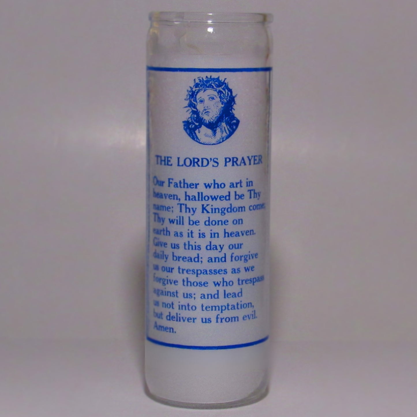 Glass candle with blue text and a religious design