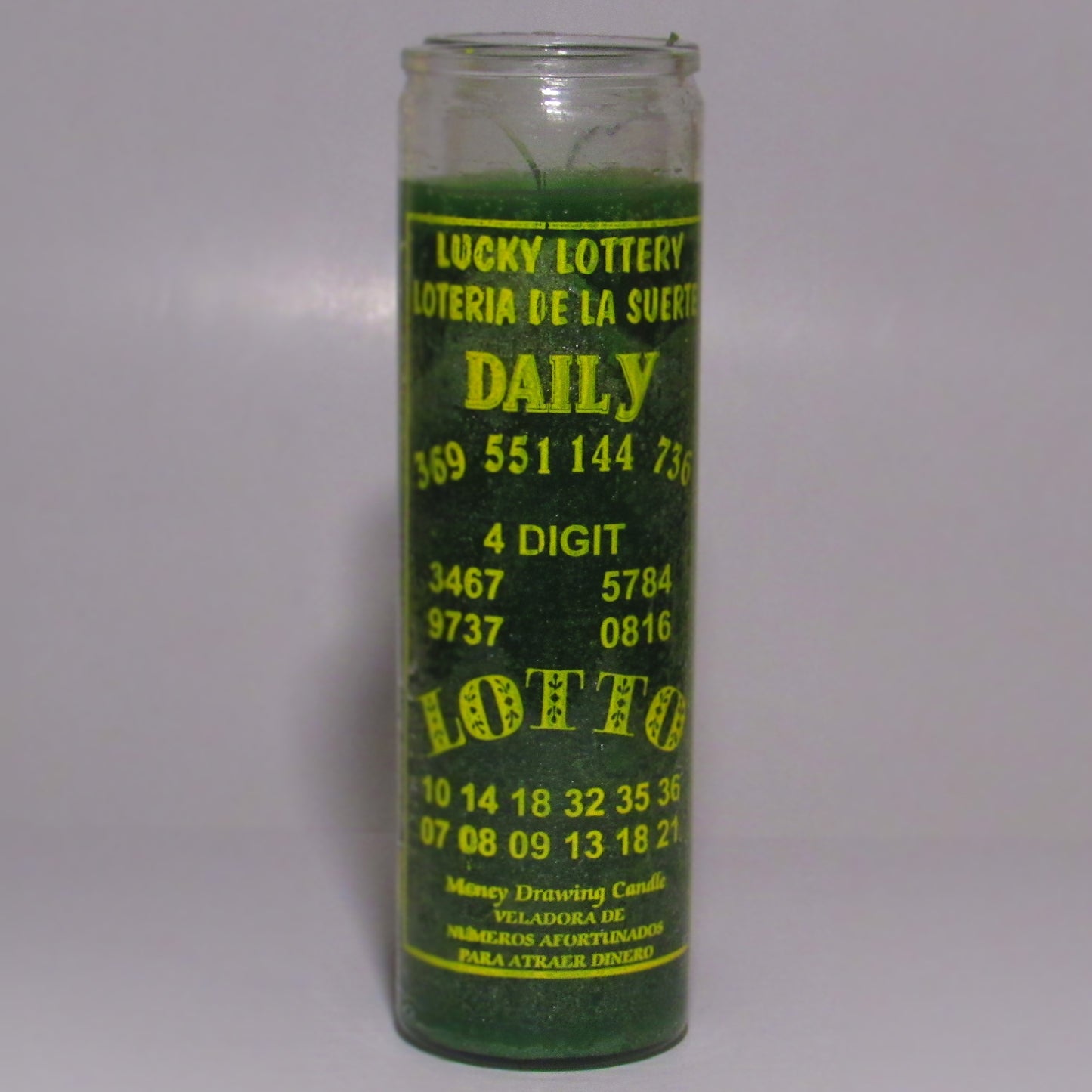 Green candle with yellow text on a white background