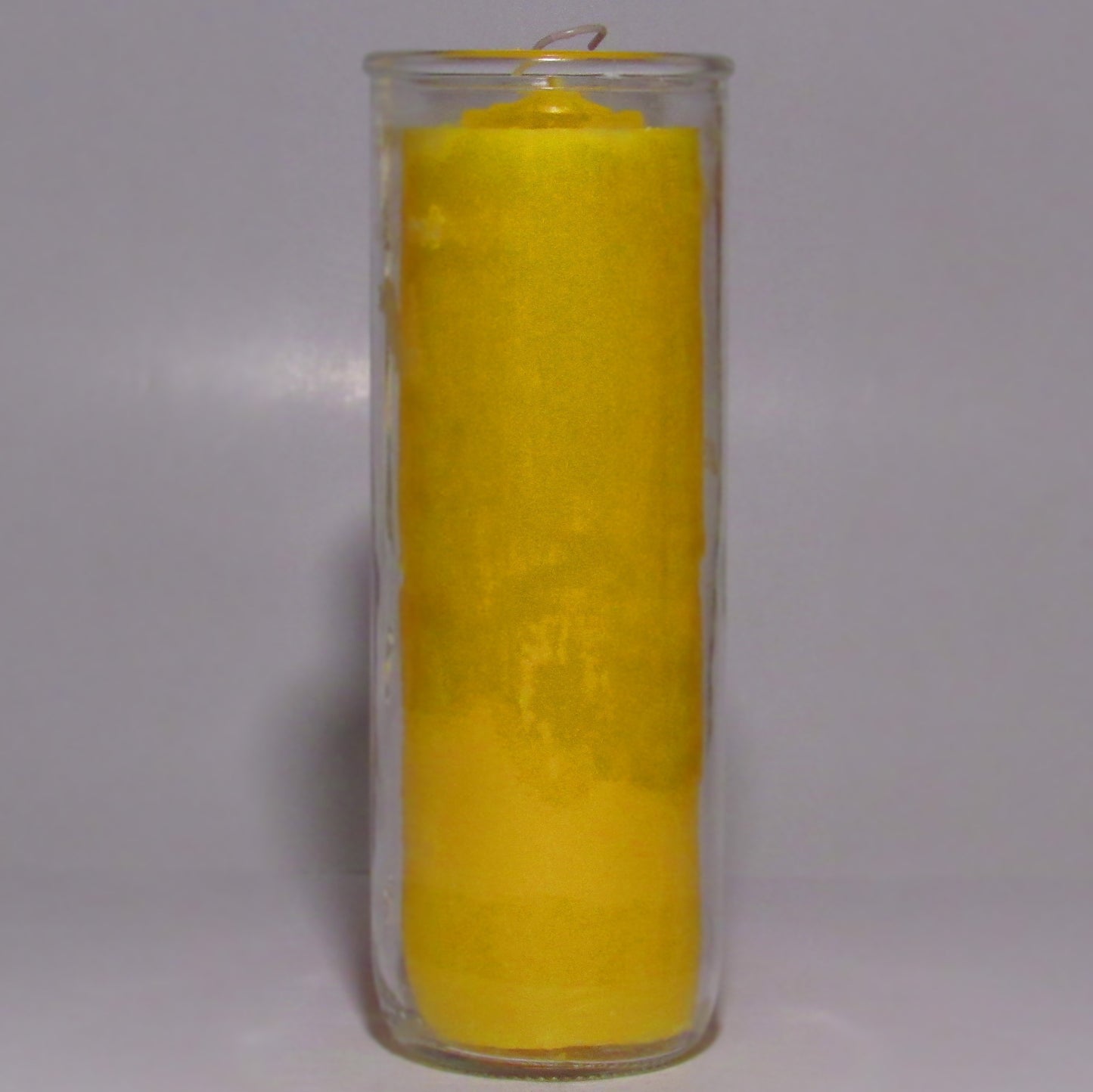 Yellow candle in a glass holder