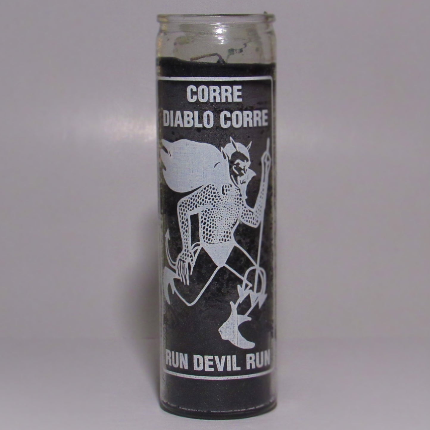 Cylindrical candle with black and white design and text