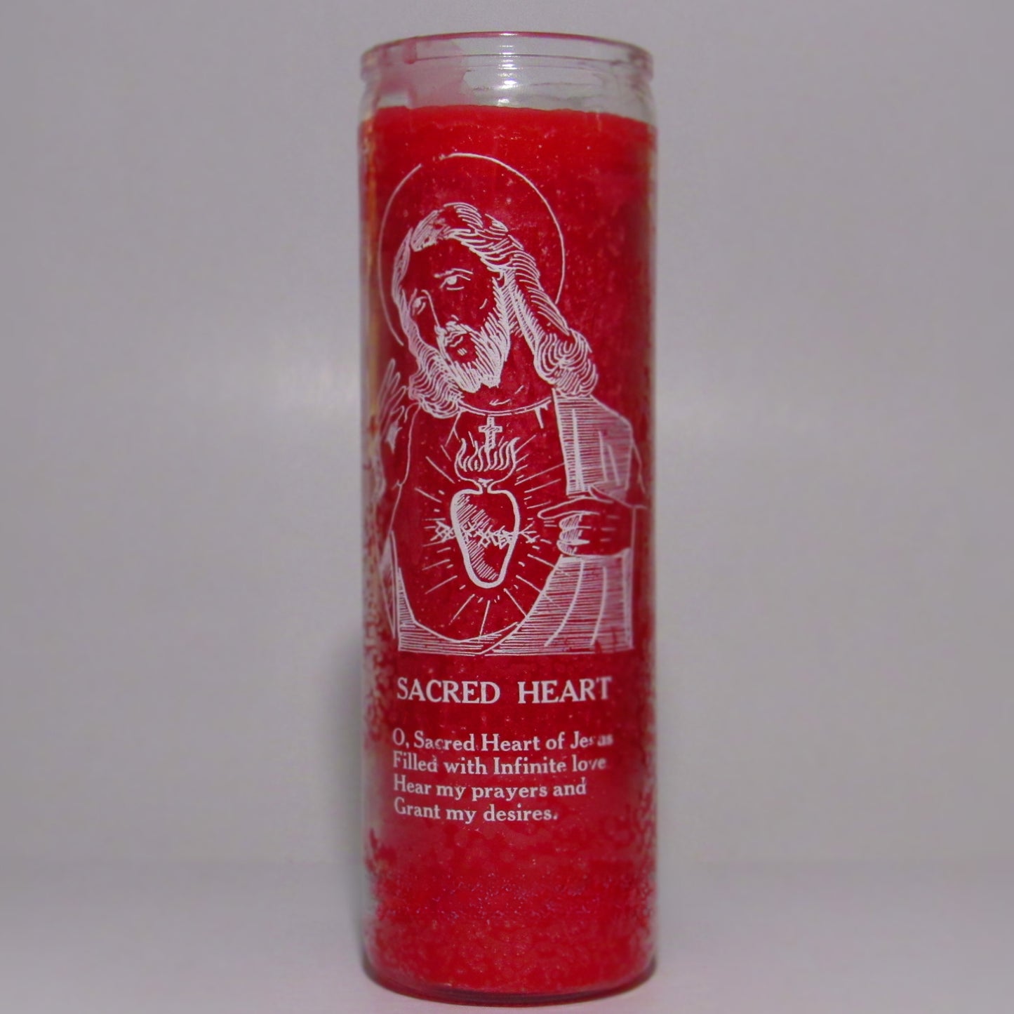 Red candle with white religious illustration and text