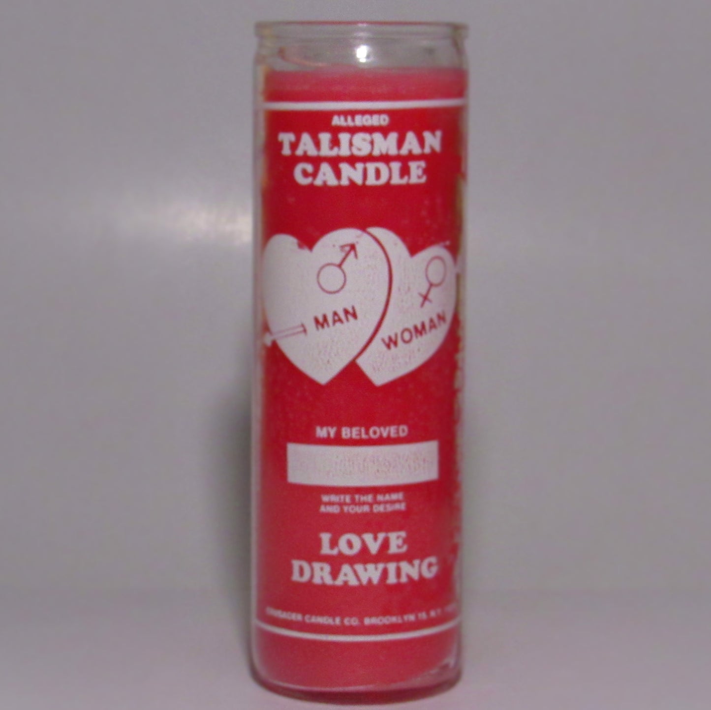 Pink candle with white text and graphics 