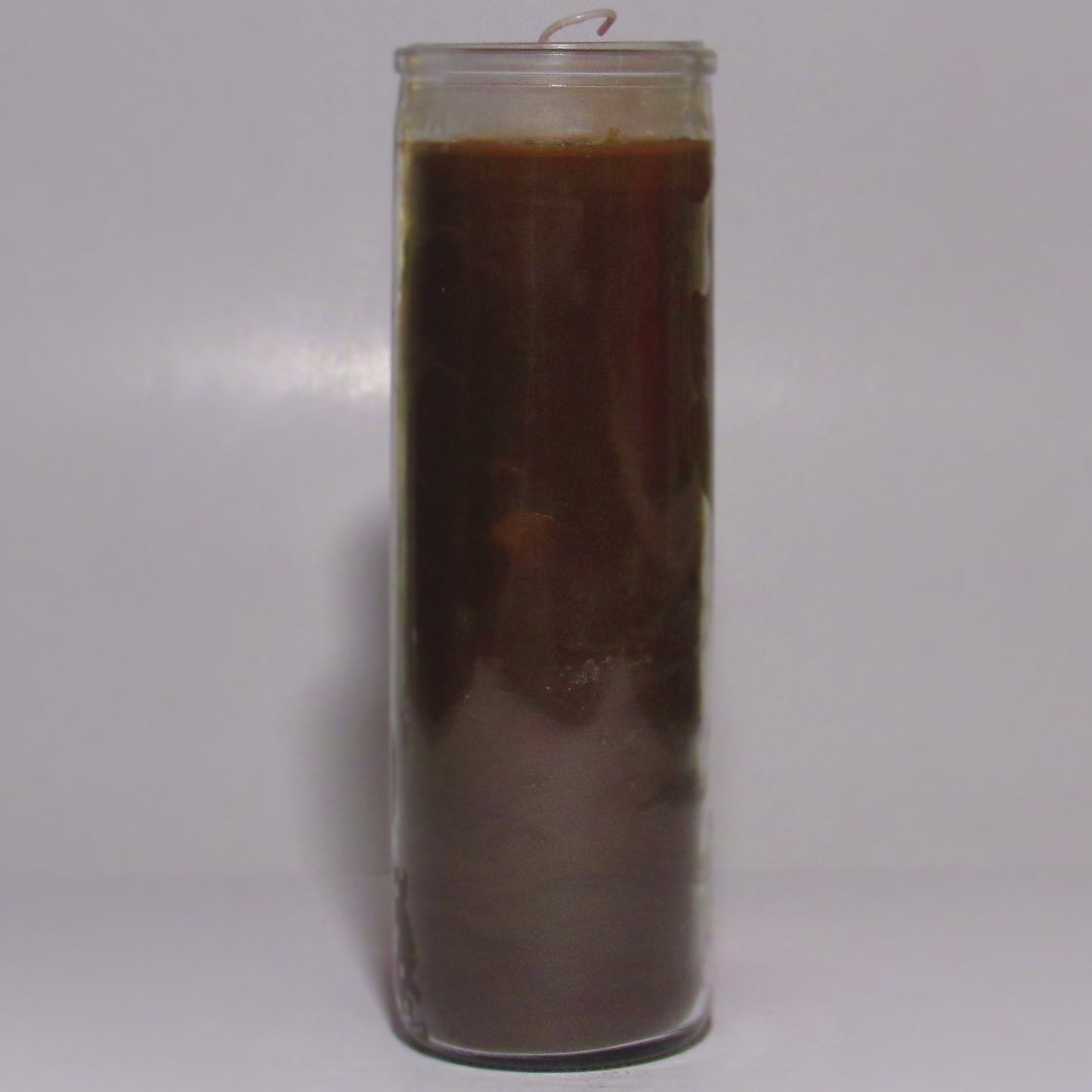 Tall glass candle with a dark brown wax 