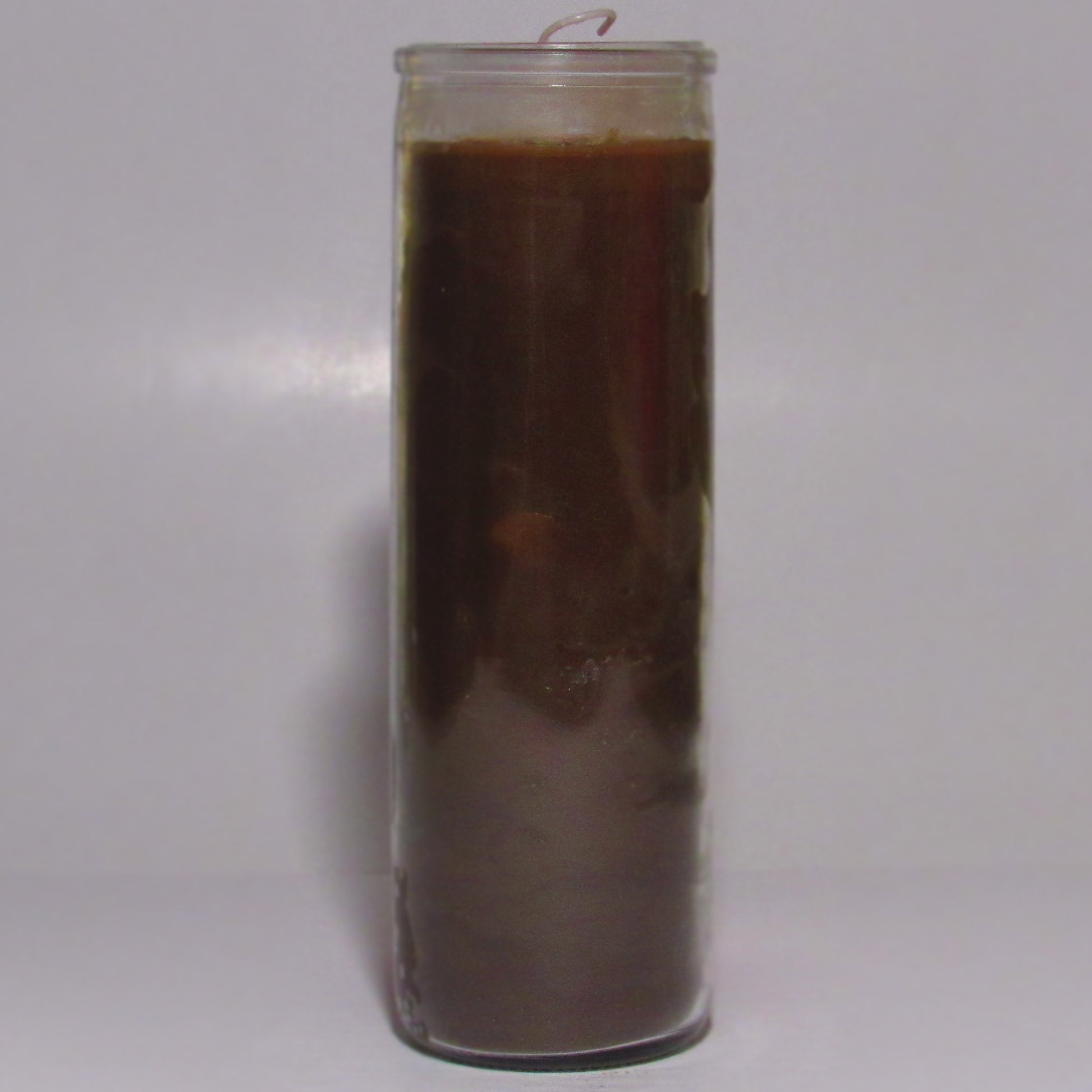 Tall glass candle with a dark brown wax 