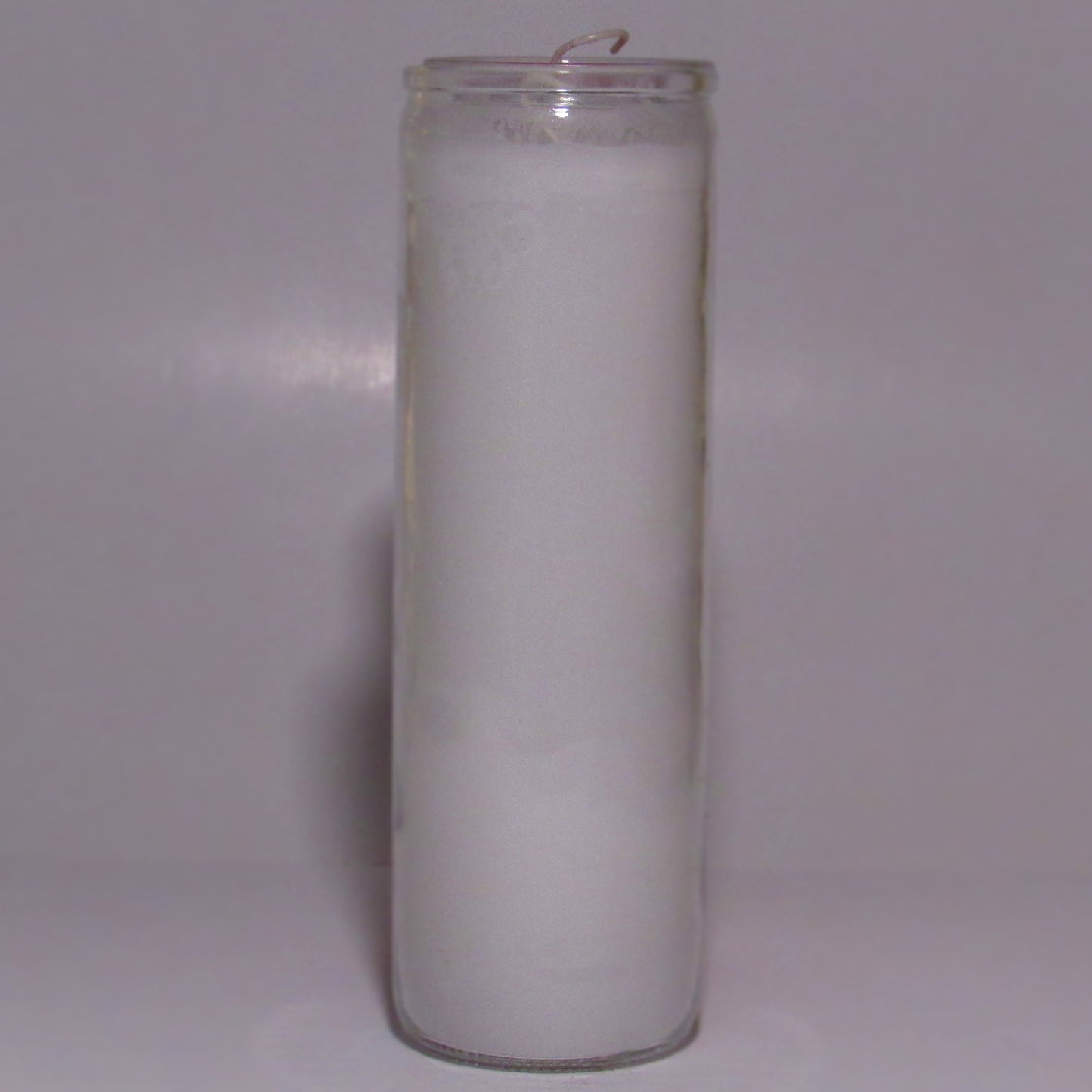 White candle in a glass holder 