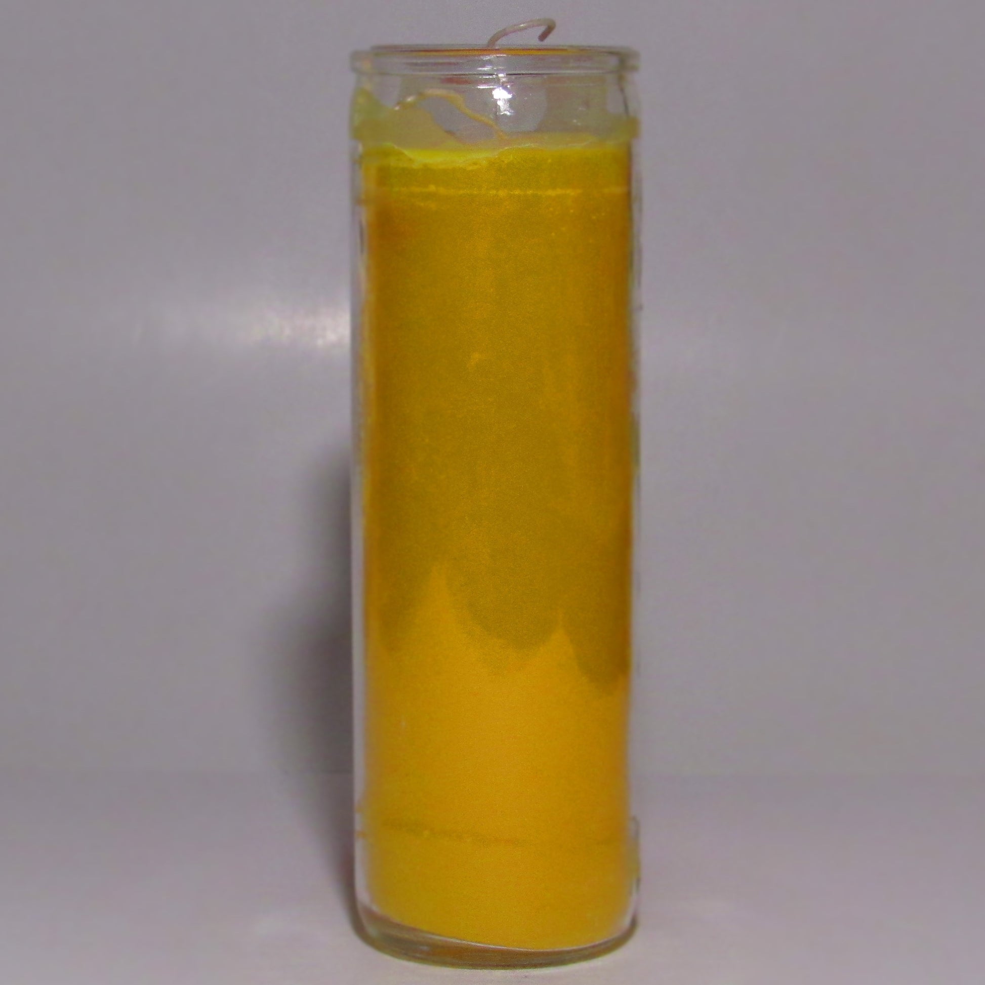 Yellow candle in a glass jar 