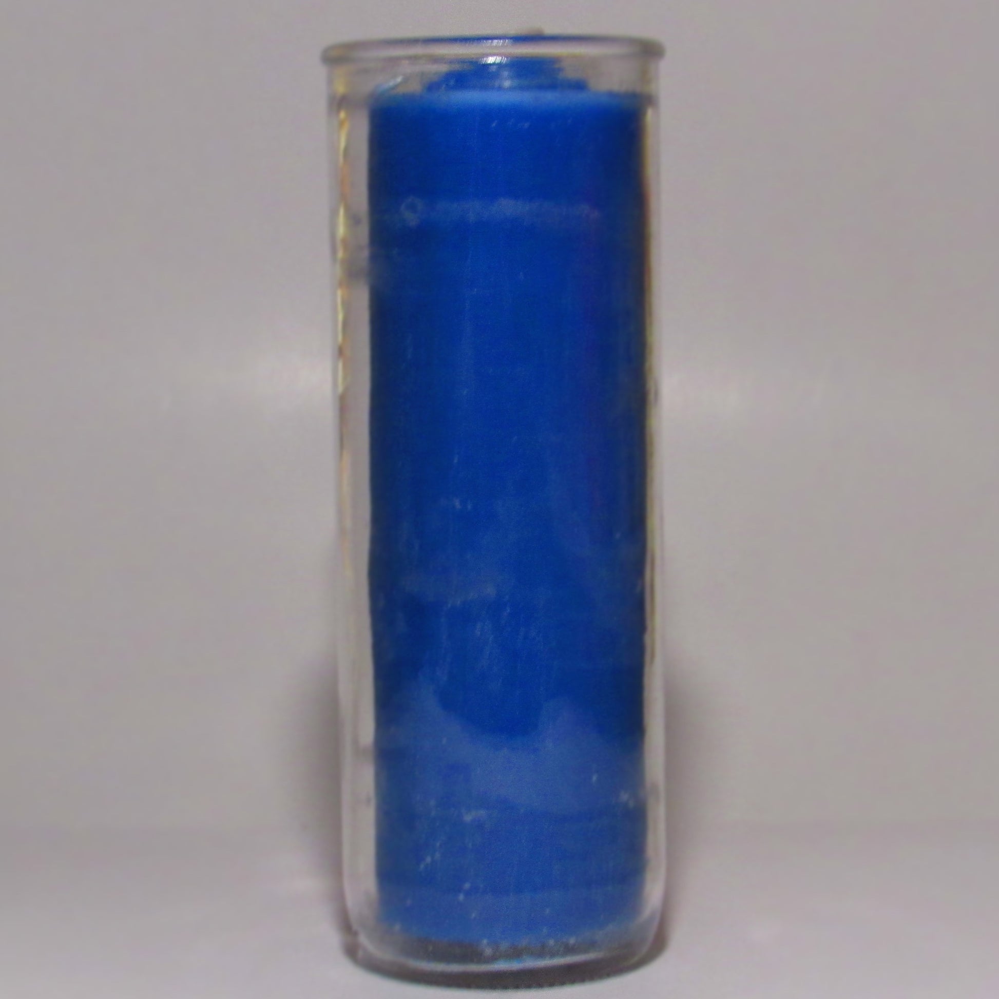 Removable Blue wax candle in a clear glass container 