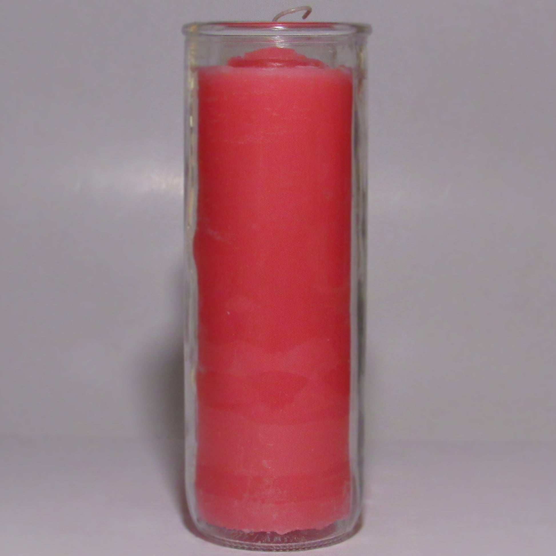 Pink candle inside a clear glass container
