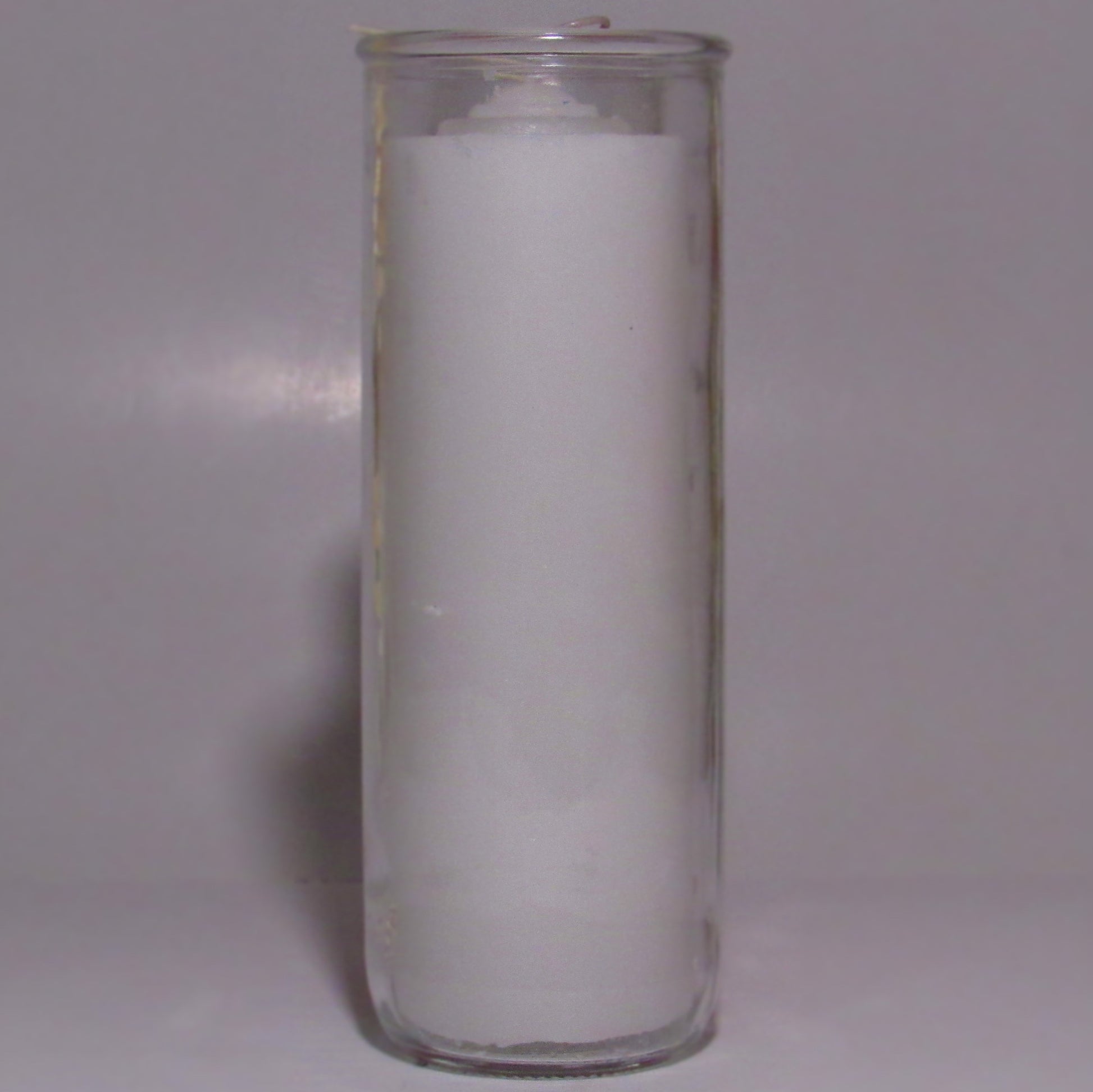 Clear glass candle holder with a white candle 