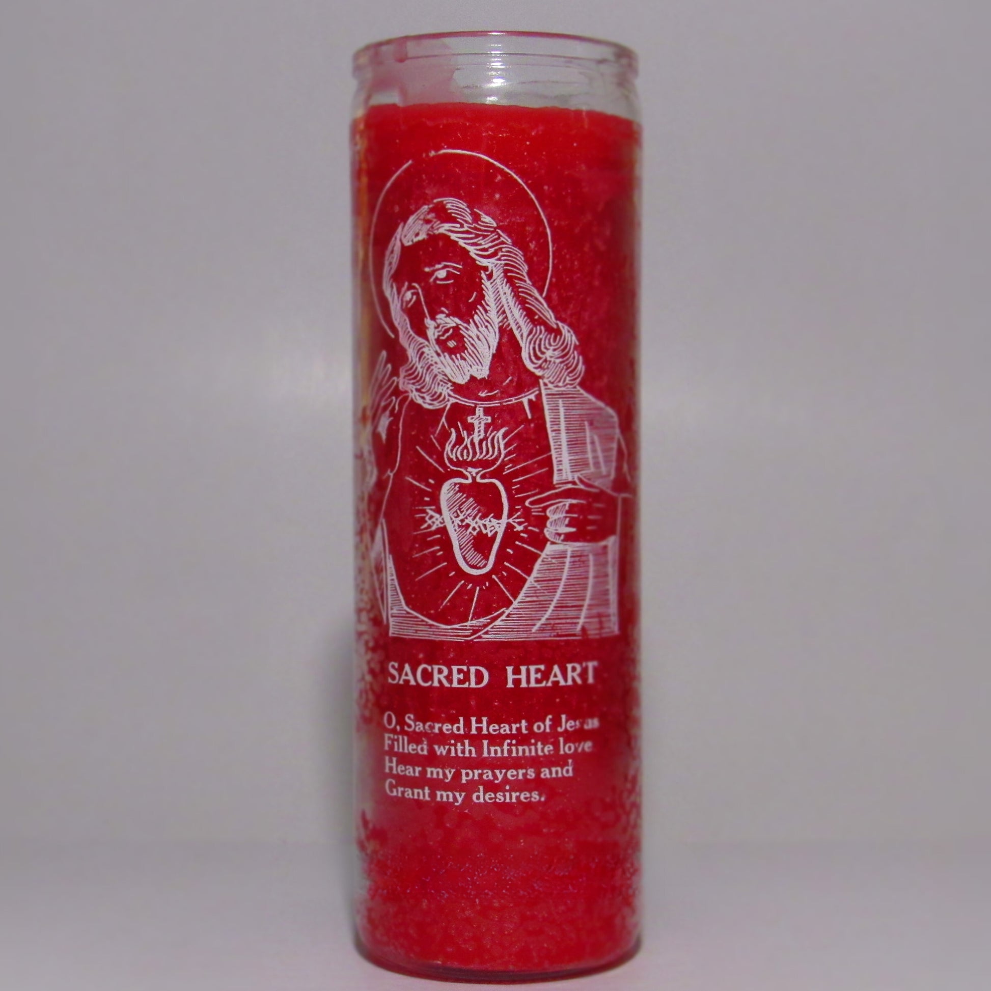 Red candle with white religious illustration and text 