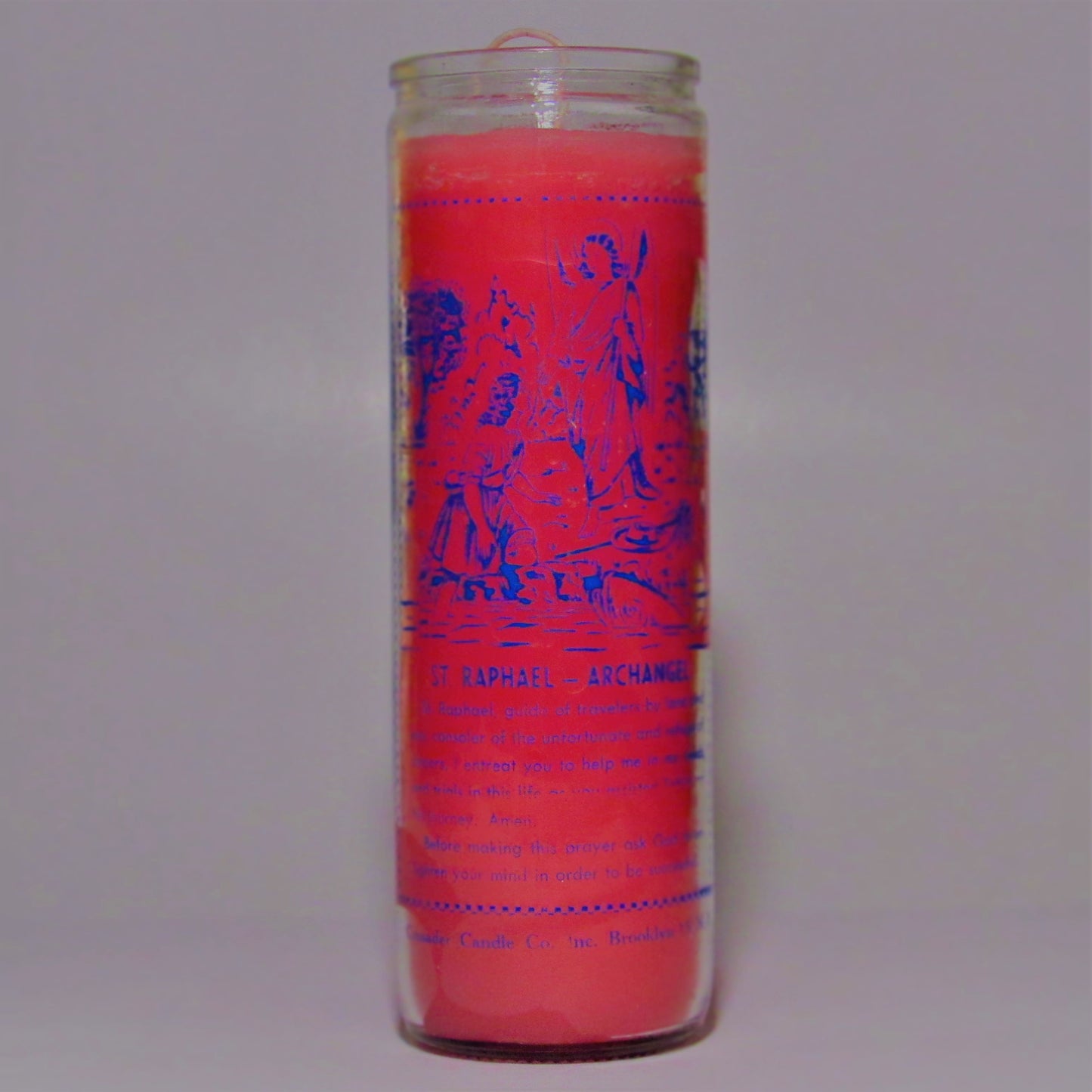 Pink candle with blue text and graphics 